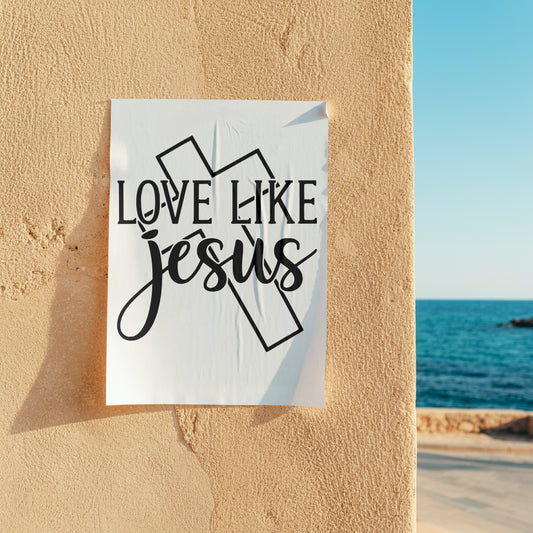 Poster with 'Love Like Jesus' text on a wall with ocean view
