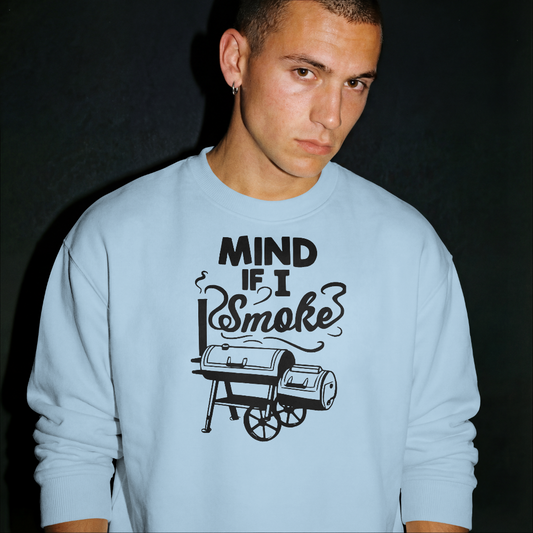 Person wearing a light blue sweatshirt with a graphic and text on a black background