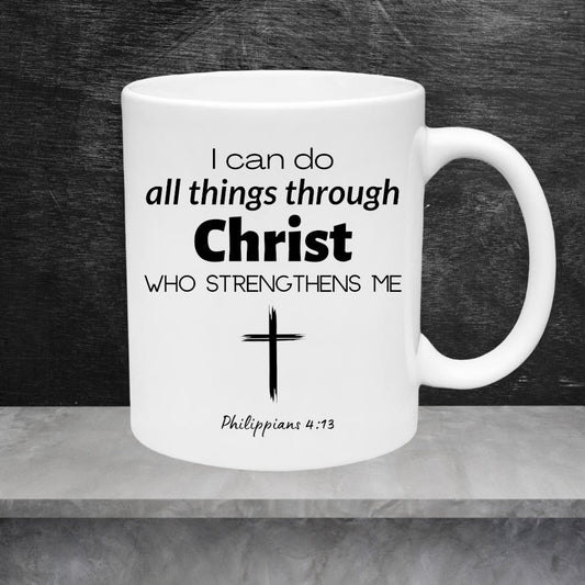 White mug with black text 'I can do all things through Christ who strengthens me' and a cross