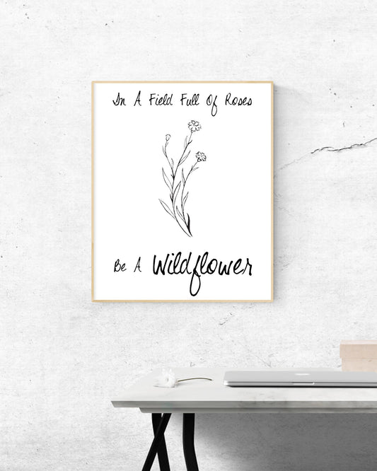 'Be a Wildflower in a field of roses' inspiring black and white digital design.