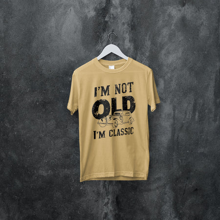 "Nostalgic car illustration with 'I'm not old, I'm classic' slogan for vintage style apparel."