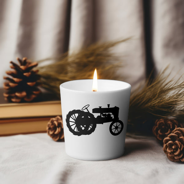 Black silhouette of an old farm tractor on white background
