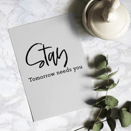 "Artistic handwritten reminder 'Tomorrow needs you' in subtle script below 'Stay'."