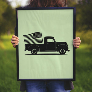 "Silhouette of a vintage black truck with American flag waving from the rear."