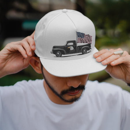 "Vintage truck and American flag in black and white, symbolizing American heritage."