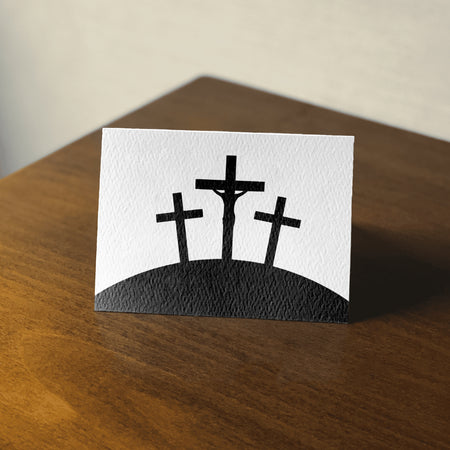 "Symbolic Christian graphic of the crucifixion with three black crosses."