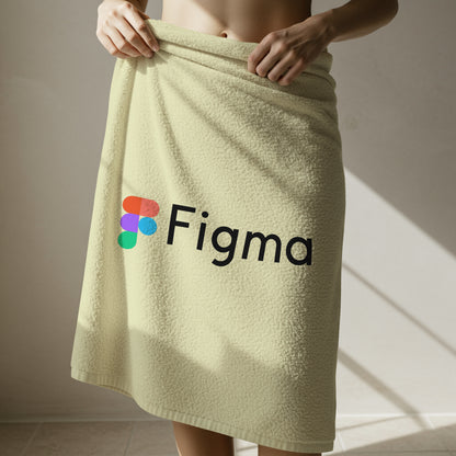 Beige towel with Figma logo draped over a person, against a neutral background