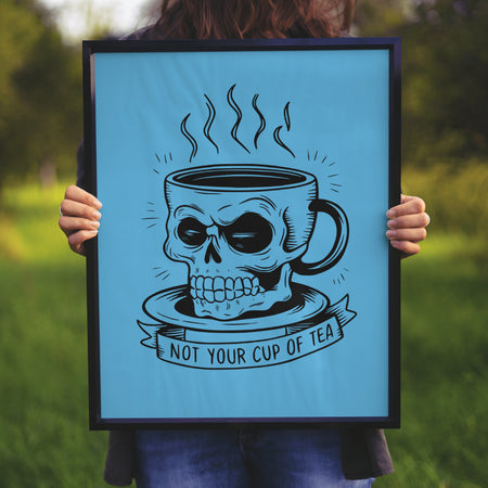 "Illustration of a skull-shaped cup on a saucer with 'Not Your Cup of Tea' text."