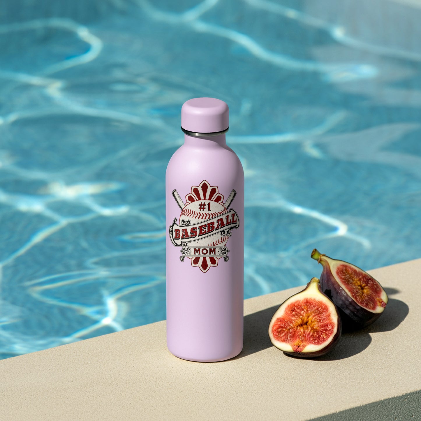 Pink water bottle with 'Baseball Mom' design next to figs by a pool