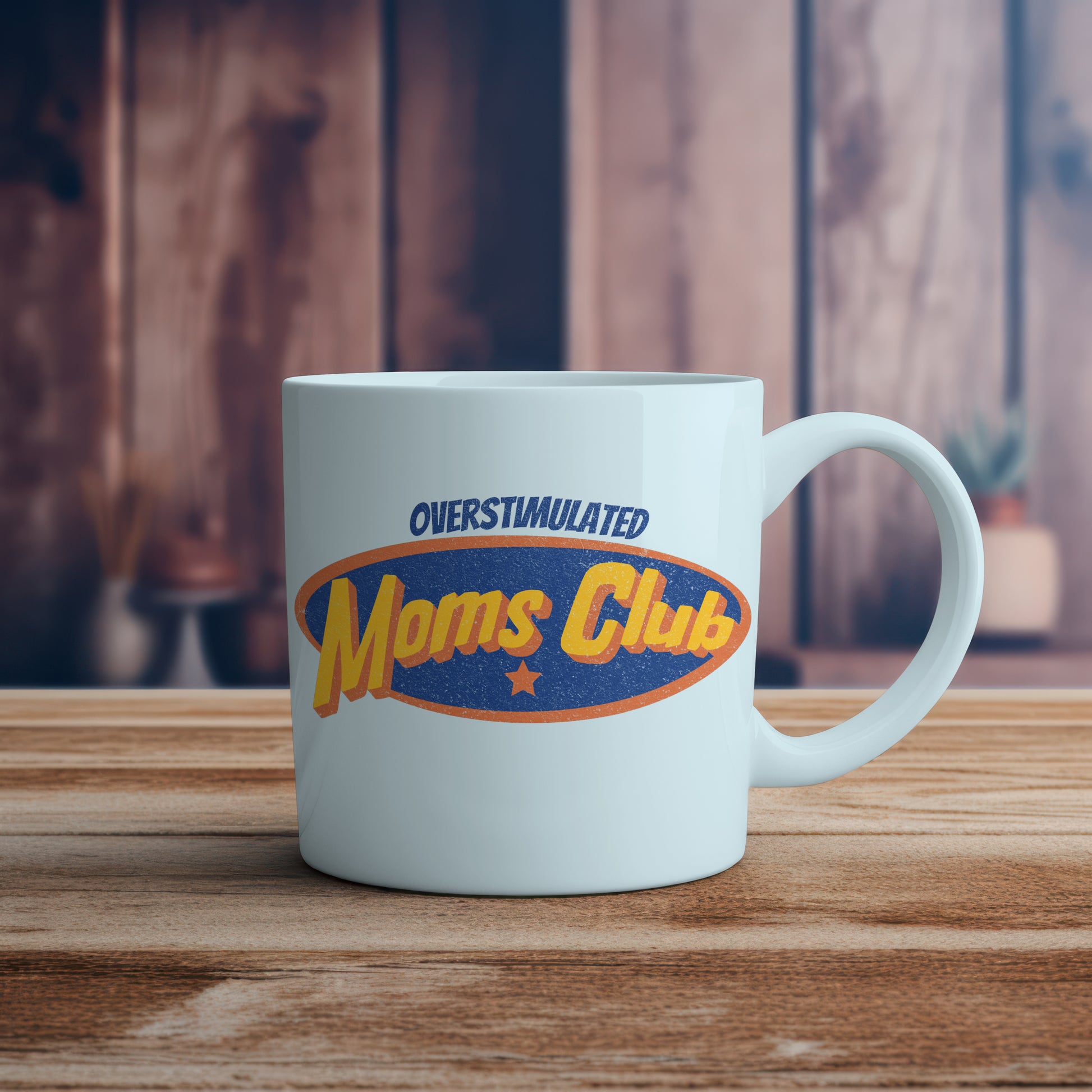 White mug with 'Overstimulated Moms Club' design on a wooden surface