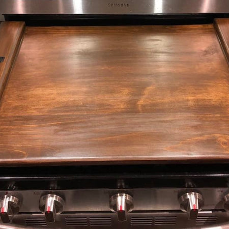 Rustic wood stove top cover with farmhouse design
