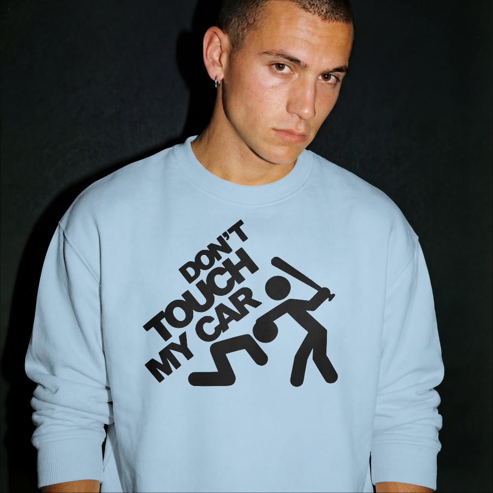 Person wearing a light blue sweatshirt with 'Don't Touch My Car' text and graphic.