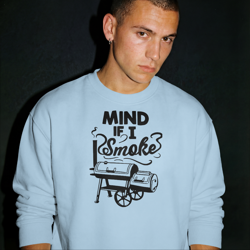 Person wearing a light blue sweatshirt with a graphic and text on a black background