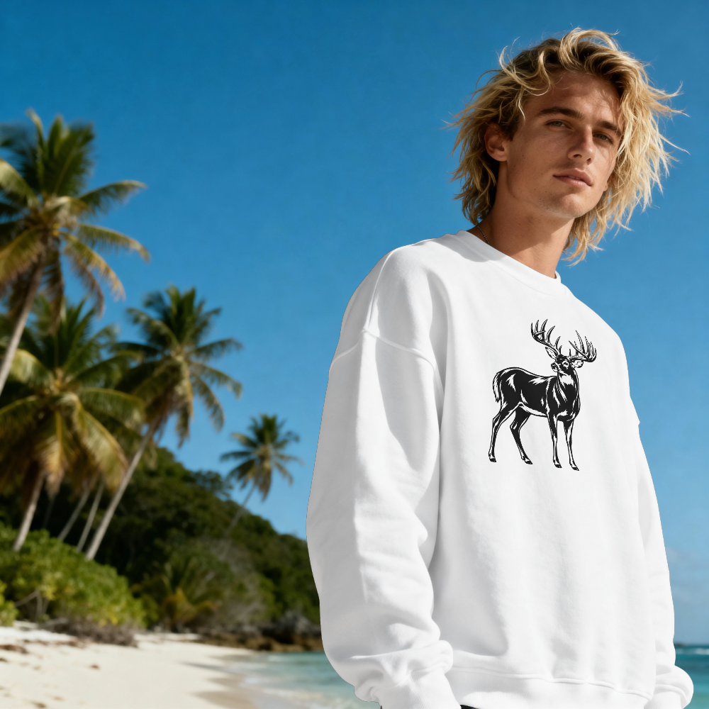 Person wearing a white sweatshirt with a black deer graphic on a tropical beach