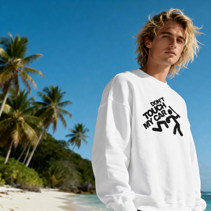 Person wearing a white sweatshirt with text on a beach with palm trees