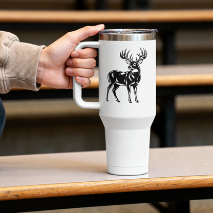 White travel mug with a black deer design held by a person on a wooden table.