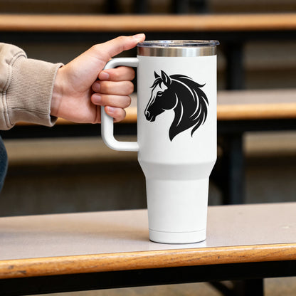 A white insulated travel mug with a black horse head graphic, held by a person's hand on a wooden table in a blurred indoor setting.