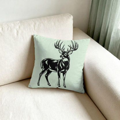 Decorative pillow with a deer design on a light green background, placed on a beige sofa.