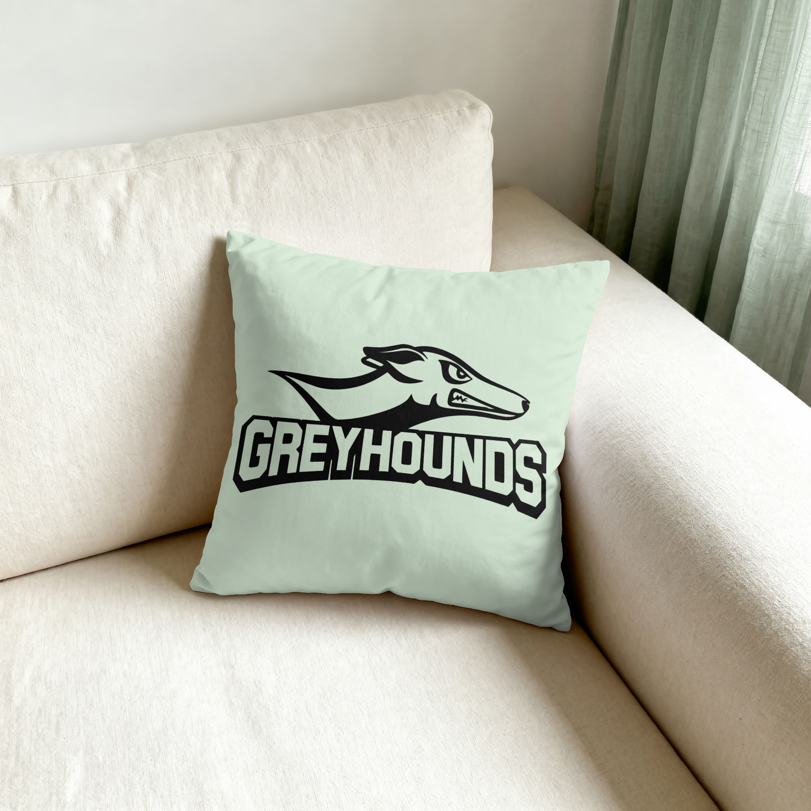 Light green pillow with 'Bolts N Holes' design on a beige couch.
