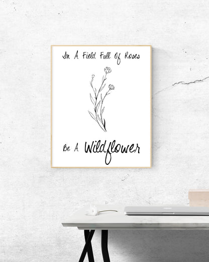 'Be a Wildflower in a field of roses' inspiring black and white digital design.