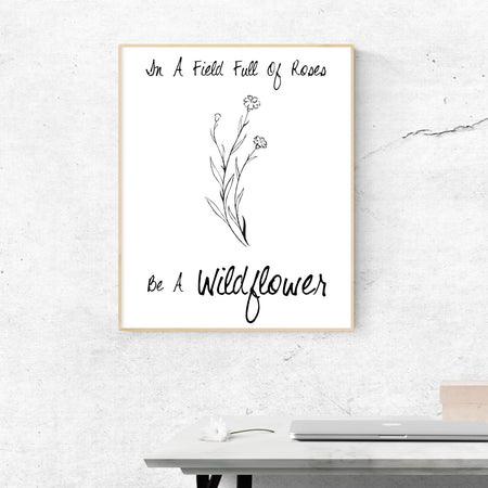 'Be a Wildflower in a field of roses' inspiring black and white digital design.