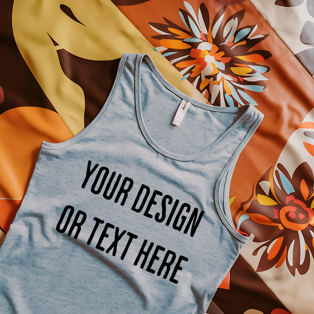 "Realistic mockup of a light gray tank top on a bright floral fabric background."