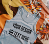 "Realistic mockup of a light gray tank top on a bright floral fabric background."